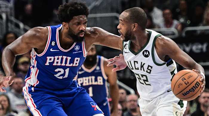 Bucks forward Khris Middleton drives for the basket against 76ers center Joel Embiid